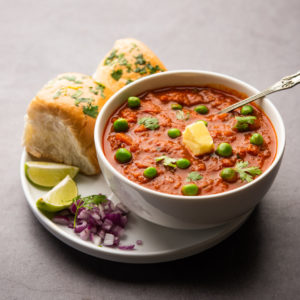 Pav bhaji is a fast food dish from India consisting of a thick vegetable curry served with a soft bread roll Pav bhaji is a fast food dish from India consisting of a thick vegetable curry served with a soft bread roll